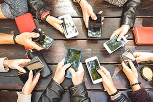 People group having addicted fun together using smartphones - Detail of hands sharing content on social network with mobile smart phones - Technology concept with millennials online with cellphones